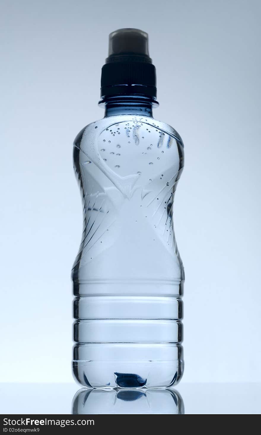 Purified mineral water on the wet glass desk with reflection