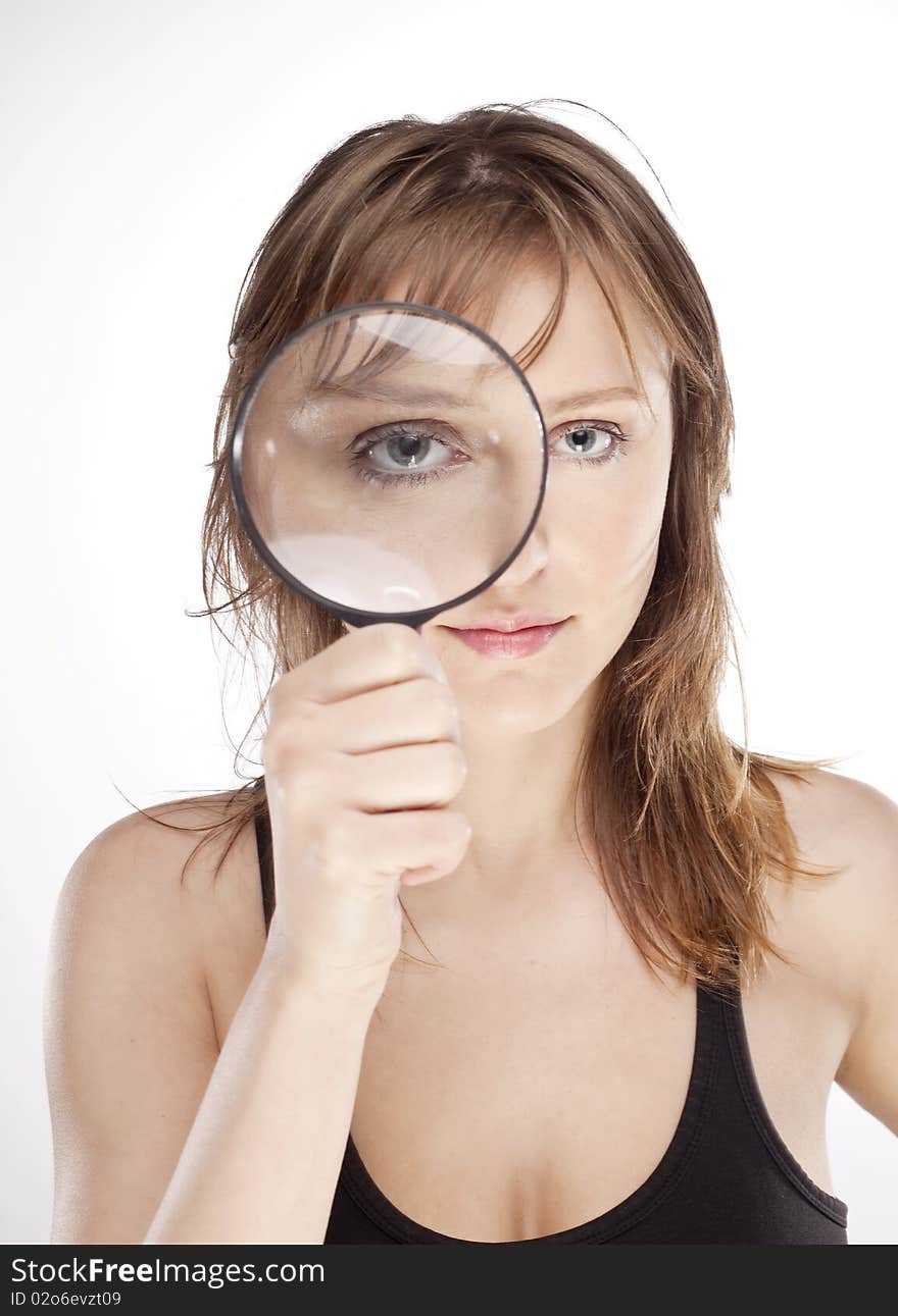 Portrait of woman with magnifier lens on eye isolated on white