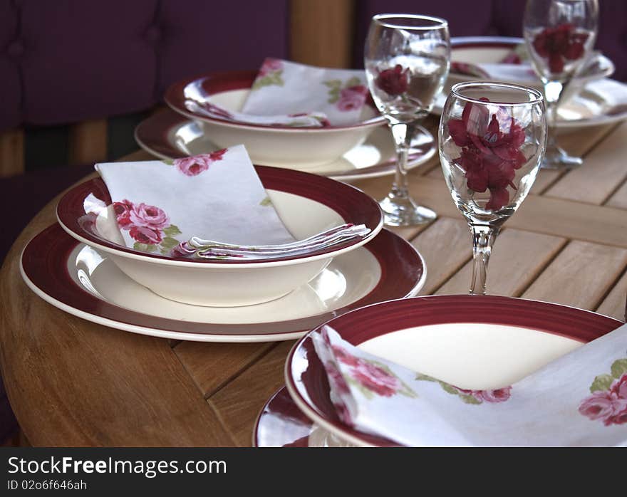 A table setting with glasses and plates. A table setting with glasses and plates