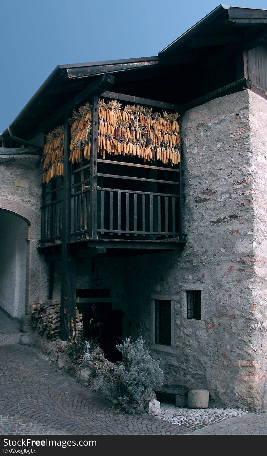 Cobs of corn being dried in the balcony of medieval building. Cobs of corn being dried in the balcony of medieval building