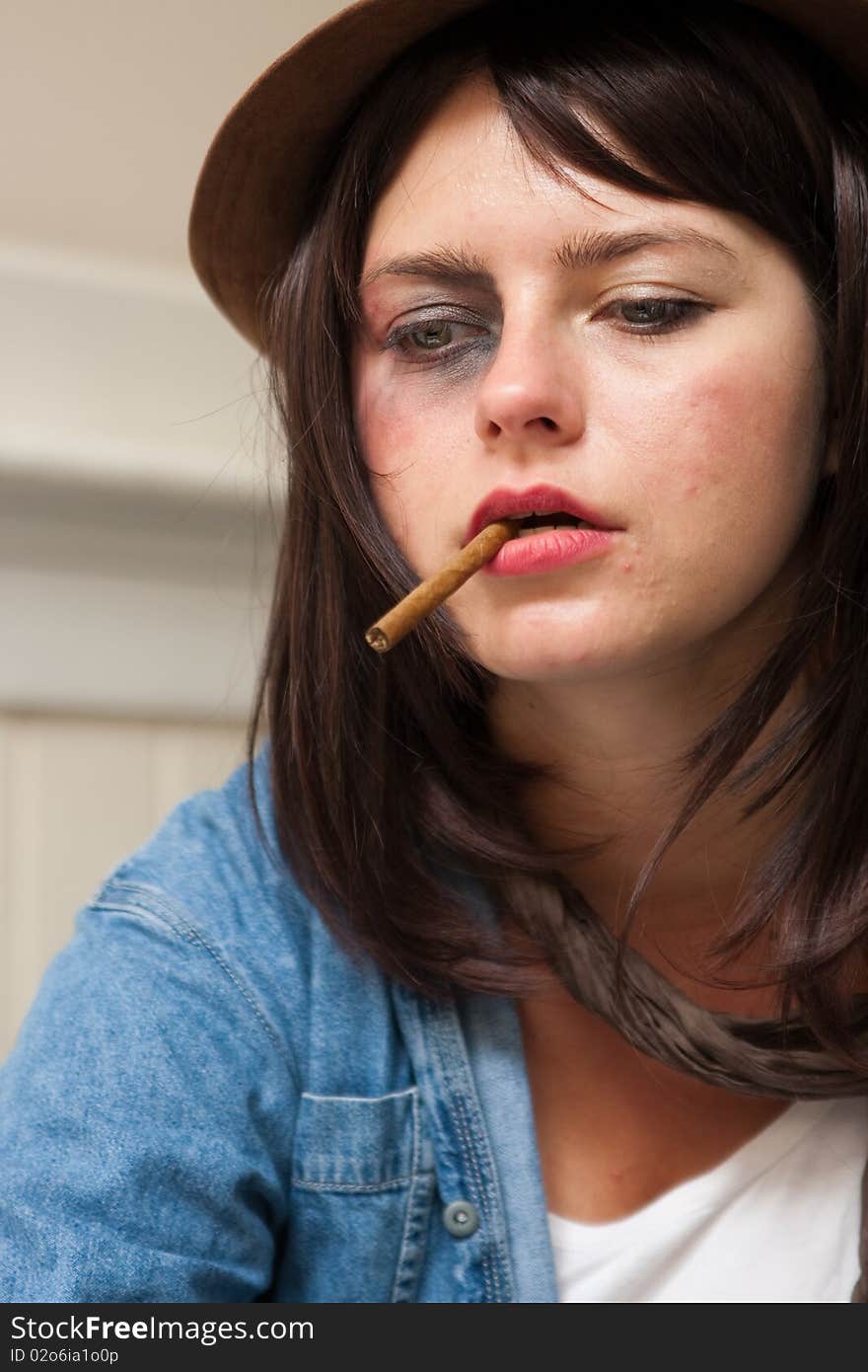 Young junkie addict woman smoking a cigar