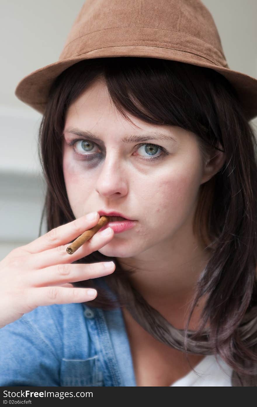 Young junkie addict woman smoking a cigar. Young junkie addict woman smoking a cigar