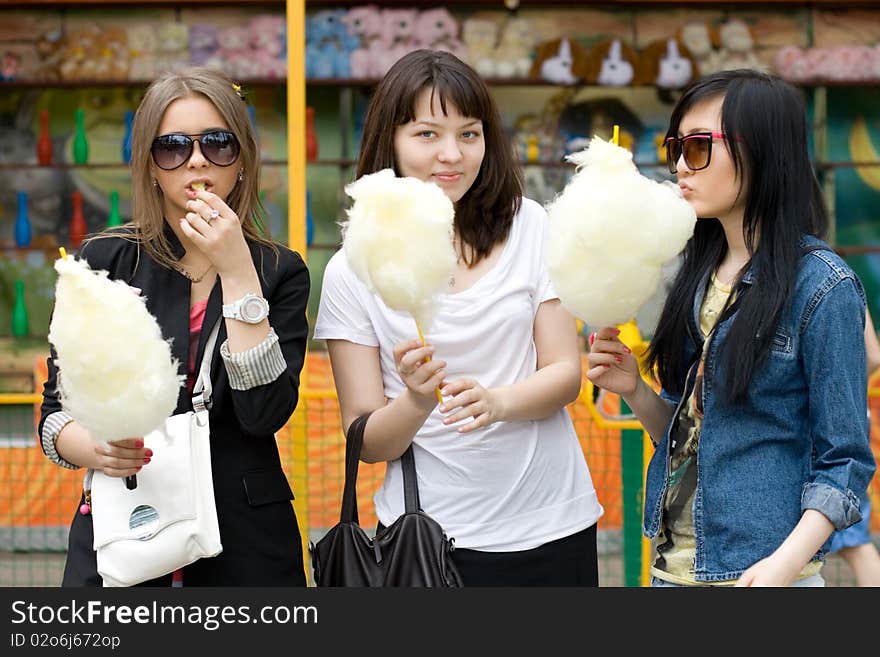 Three girls eating candy floss