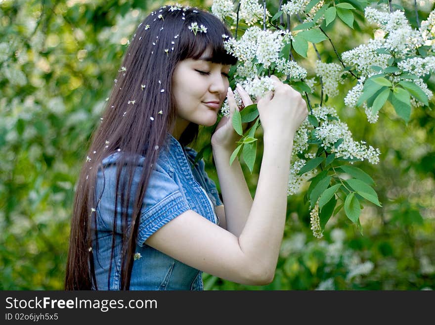 Girl standing near lilac