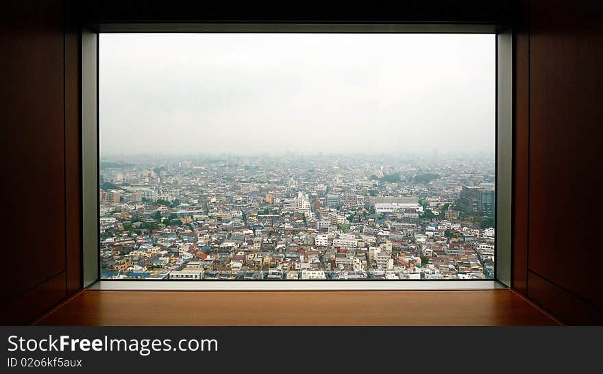 A view of the residential area of Tokyo through a window of a tower building in Setagaya. A view of the residential area of Tokyo through a window of a tower building in Setagaya