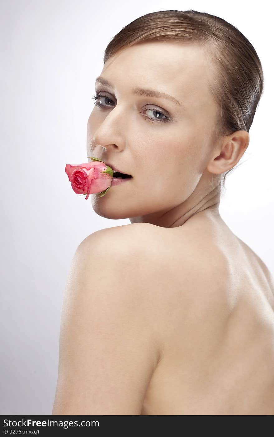 Woman with flower in her mouth