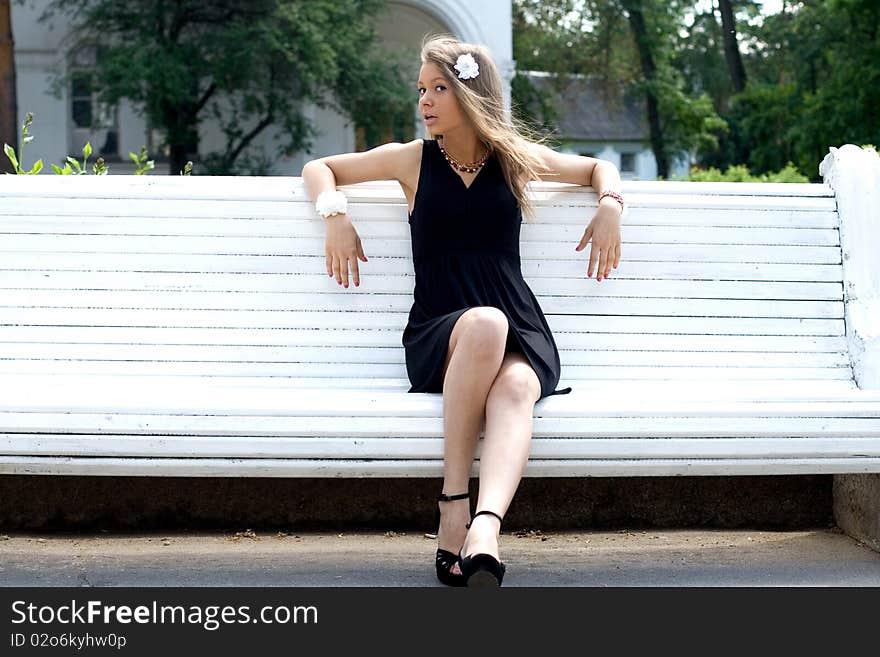 Girl sitting on bench outdoor