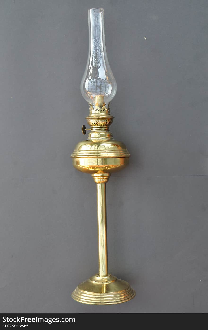 This a old brass lantern which was possibly used indoors. It has a round base filled with sand to give the base weight. The round section in the middle is where you add the fuel or paraffin. The top has a small unique glass filling to protect from the flame.