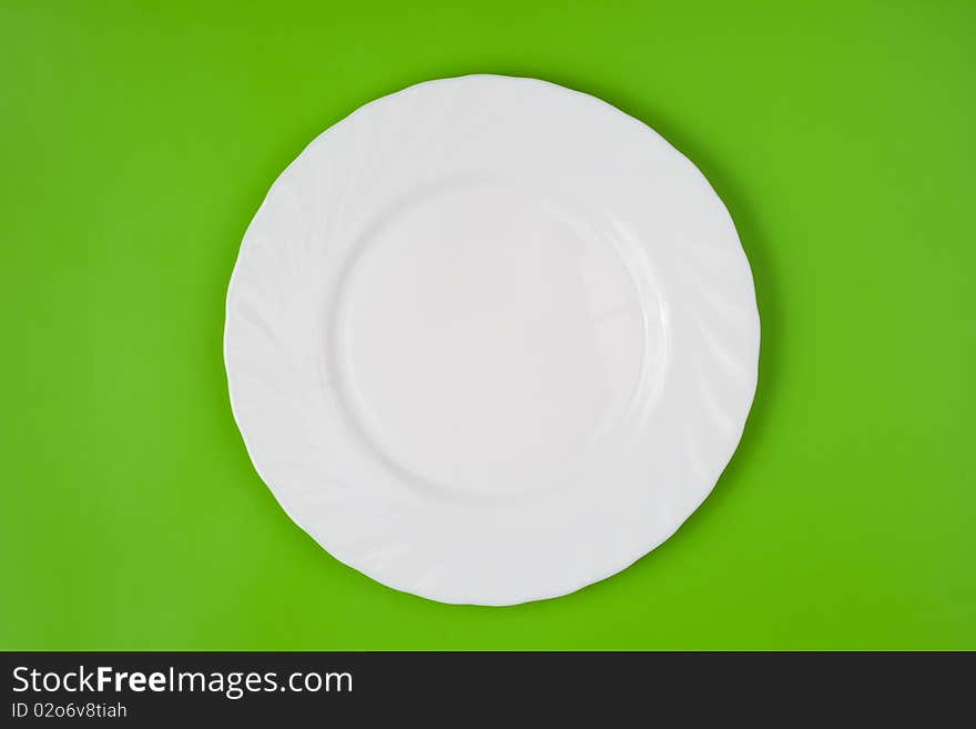 White round plate on green top view