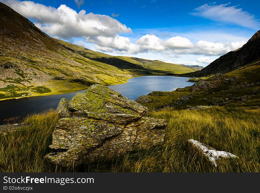 Dramatic landscape view of lake mountains and clear blue sky. Dramatic landscape view of lake mountains and clear blue sky