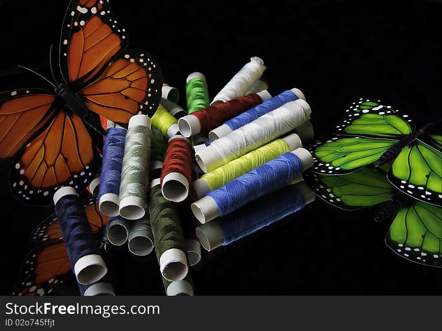 Colorful reels of thread and butterfly