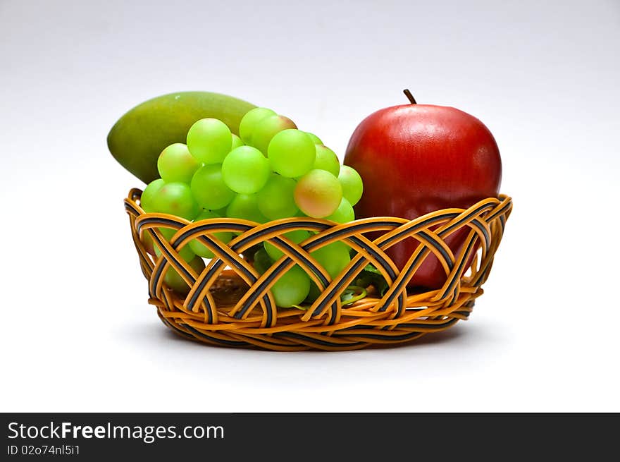 Basket with fruits, isolated on white background