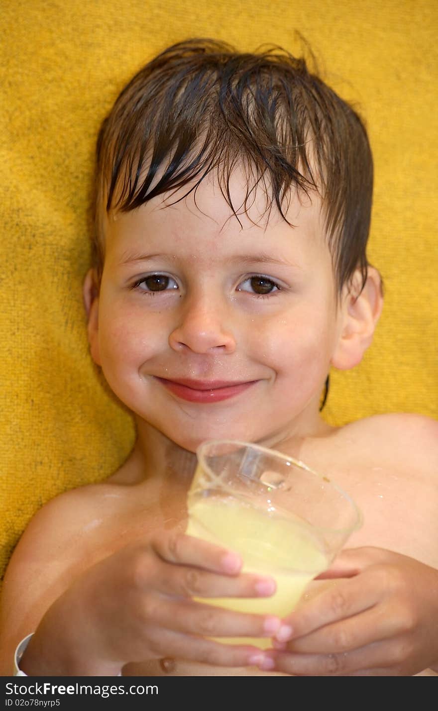 Happy small boy with the glass of juice