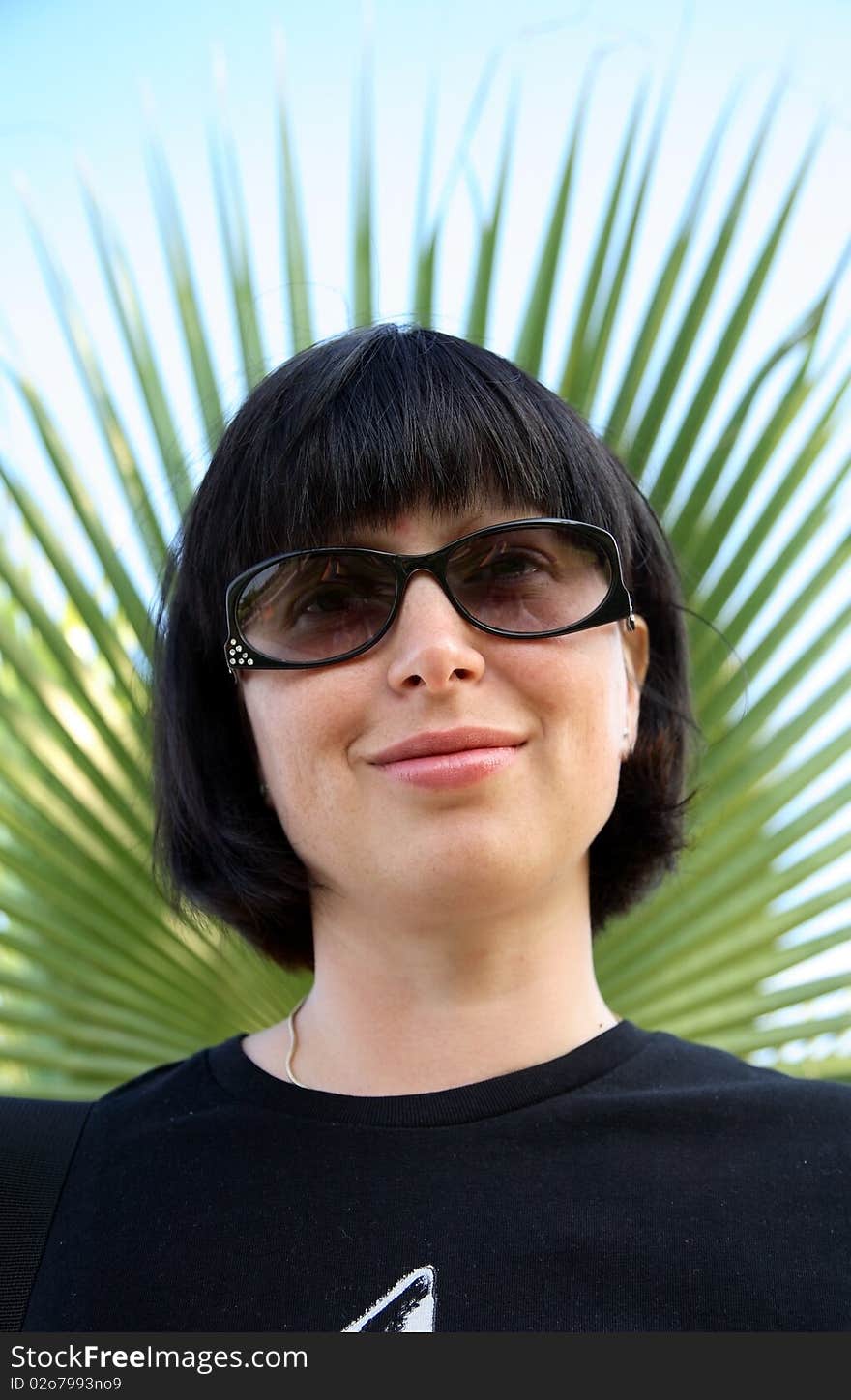 Woman In Sunglasses And Palms On Background