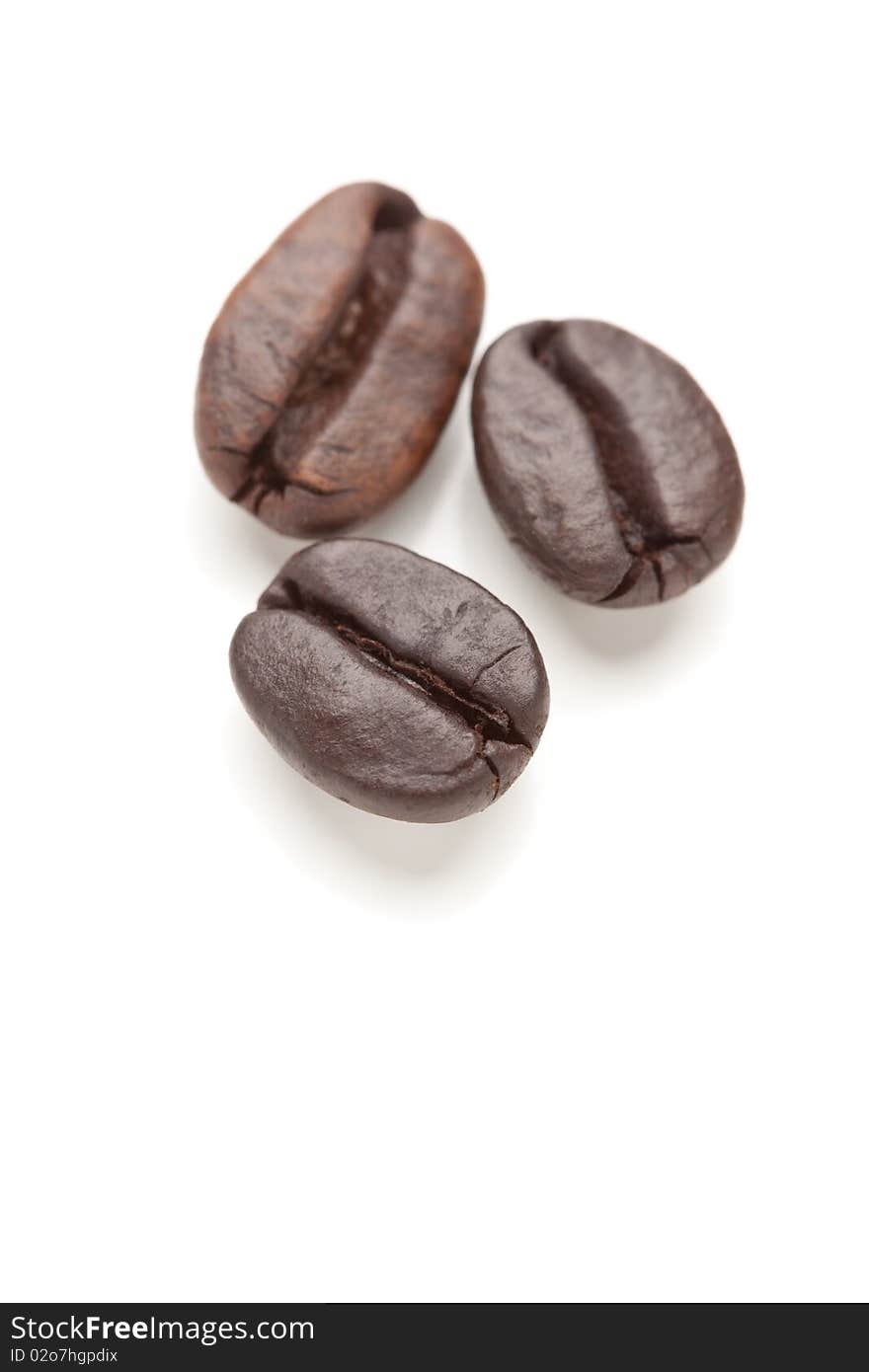 Three Roasted Coffee Beans On White