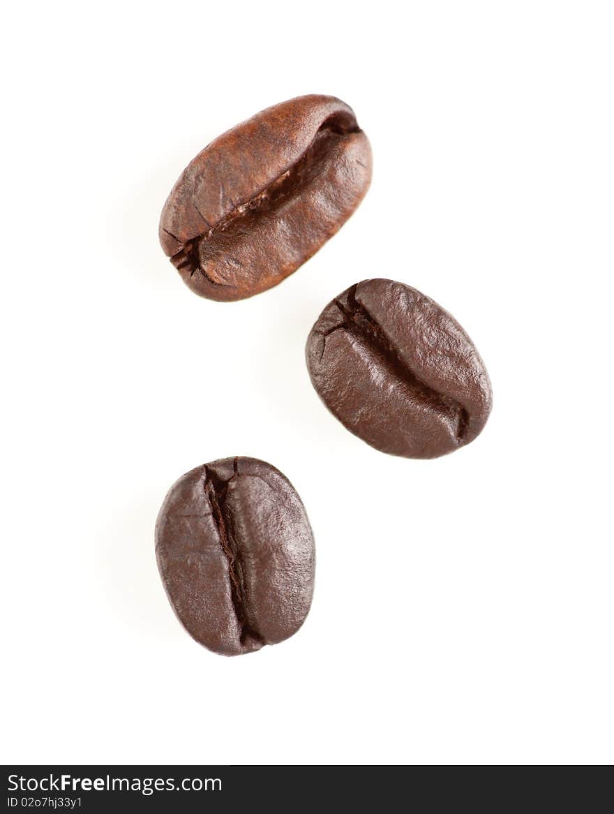 Three Roasted Coffee Beans On White