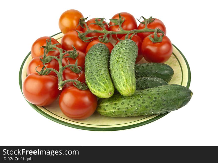 Fresh raw tomatoes and cucumbers on a plate. Fresh raw tomatoes and cucumbers on a plate