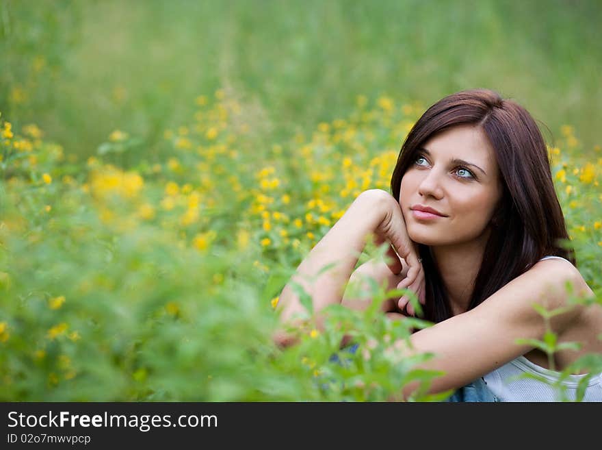 Brunette  girl in jeans in the park