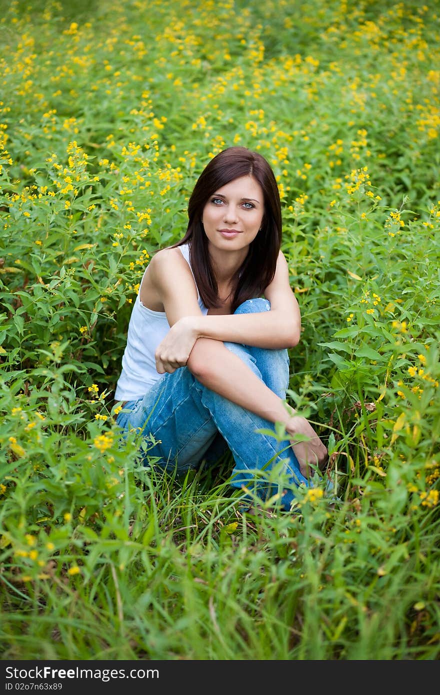 Brunette  girl in jeans in the park