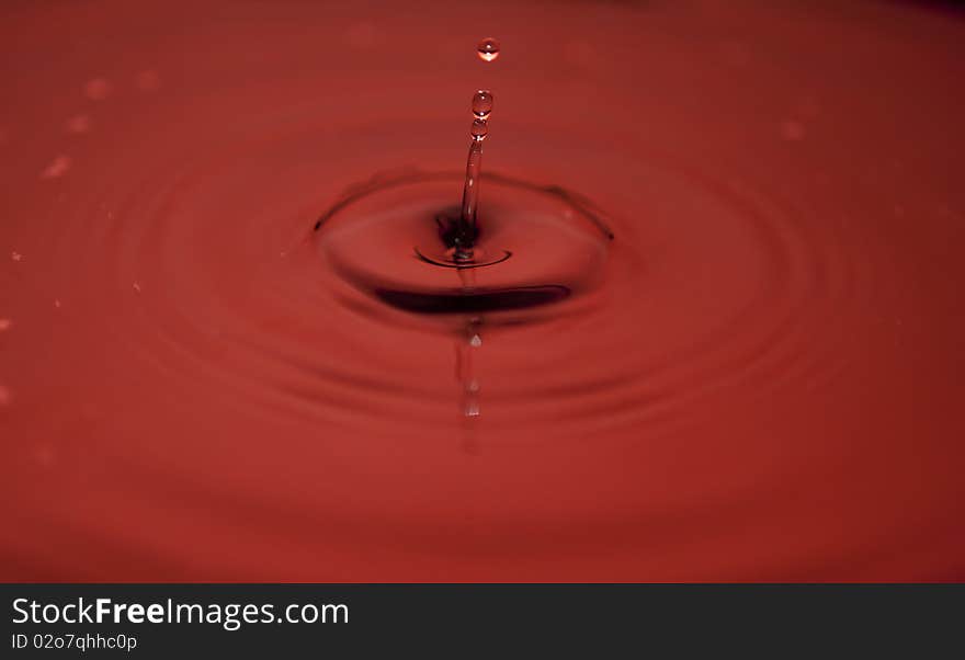 Water droplets cptured while descending on to the still water surface. Water droplets cptured while descending on to the still water surface