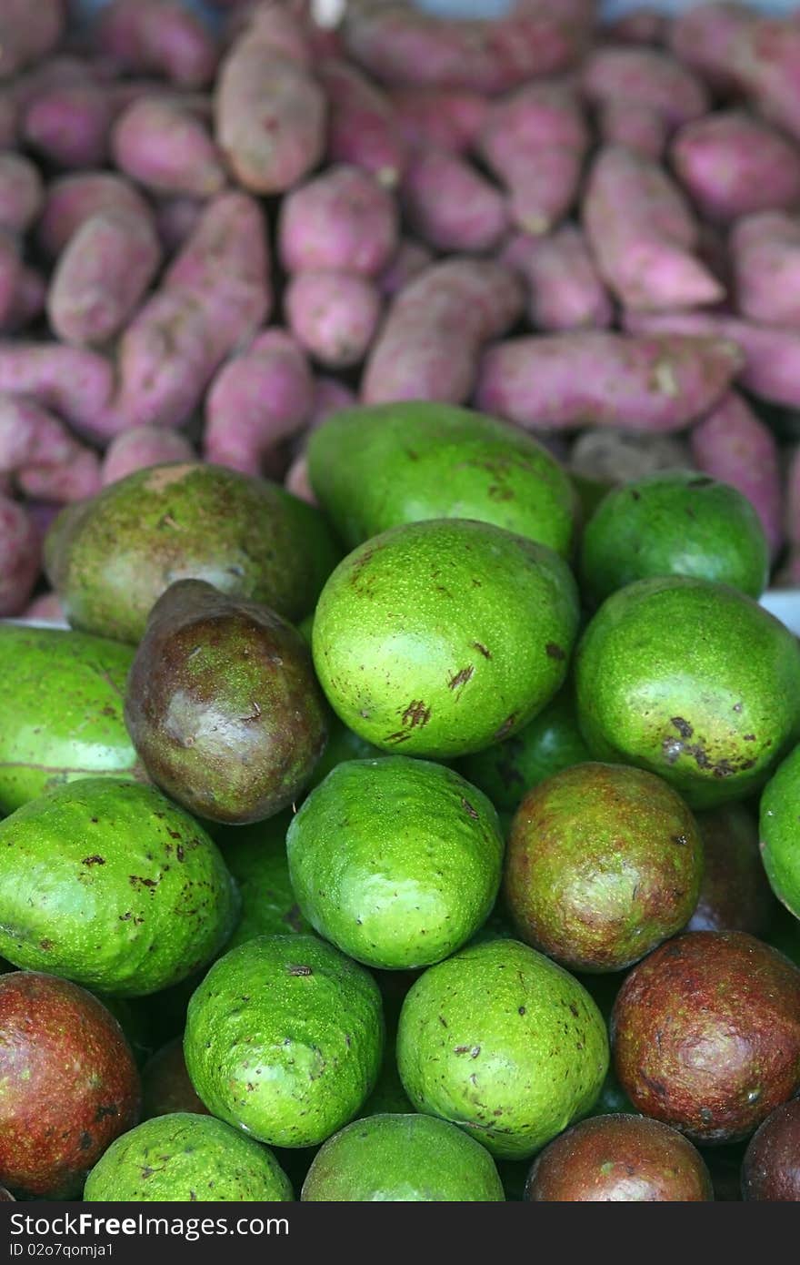 Avocados and Taro or purple yam in a fruit stand in the Philippines. Avocados and Taro or purple yam in a fruit stand in the Philippines