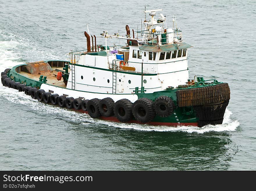 Tug boat traveling through the water. Tug boat traveling through the water