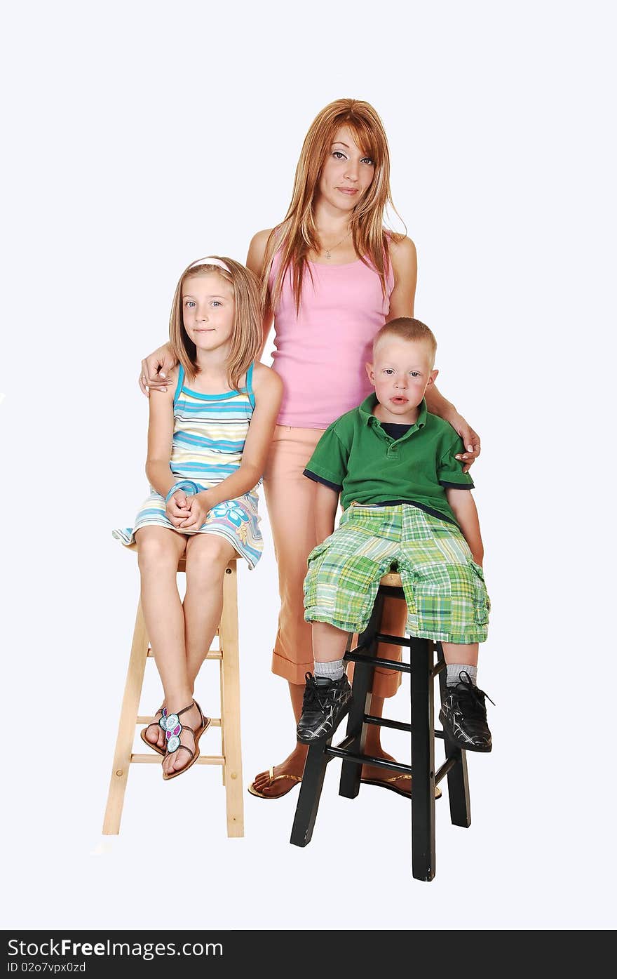 An young family, a mother with her two kids, an seven year girl and a
three year boy sitting on chairs in the studio for white background. An young family, a mother with her two kids, an seven year girl and a
three year boy sitting on chairs in the studio for white background.