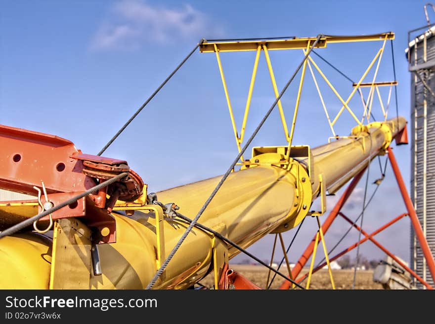 Yellow grain auger and the sky