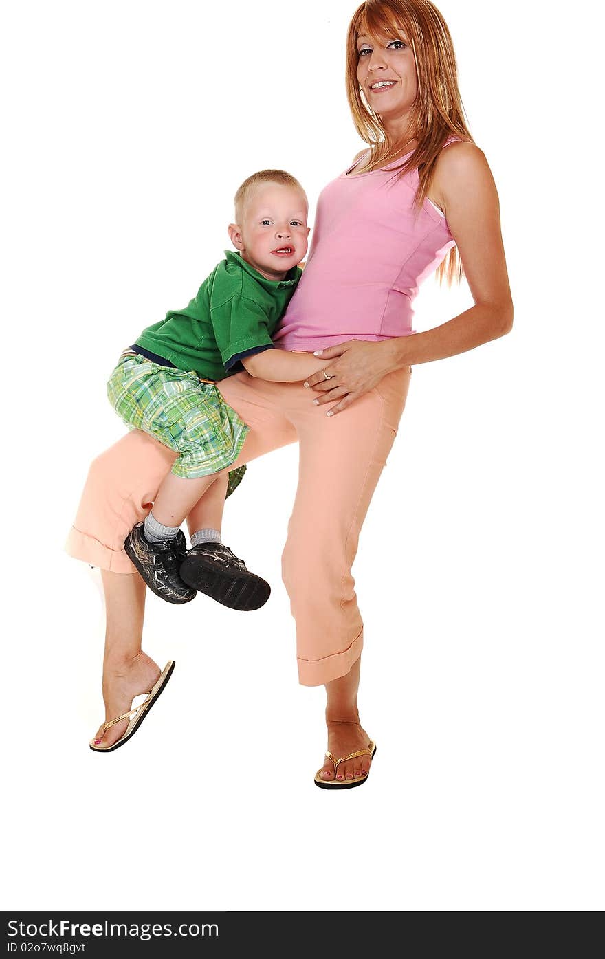 A young pretty mother playing with her small son in the studio for white background. A young pretty mother playing with her small son in the studio for white background.