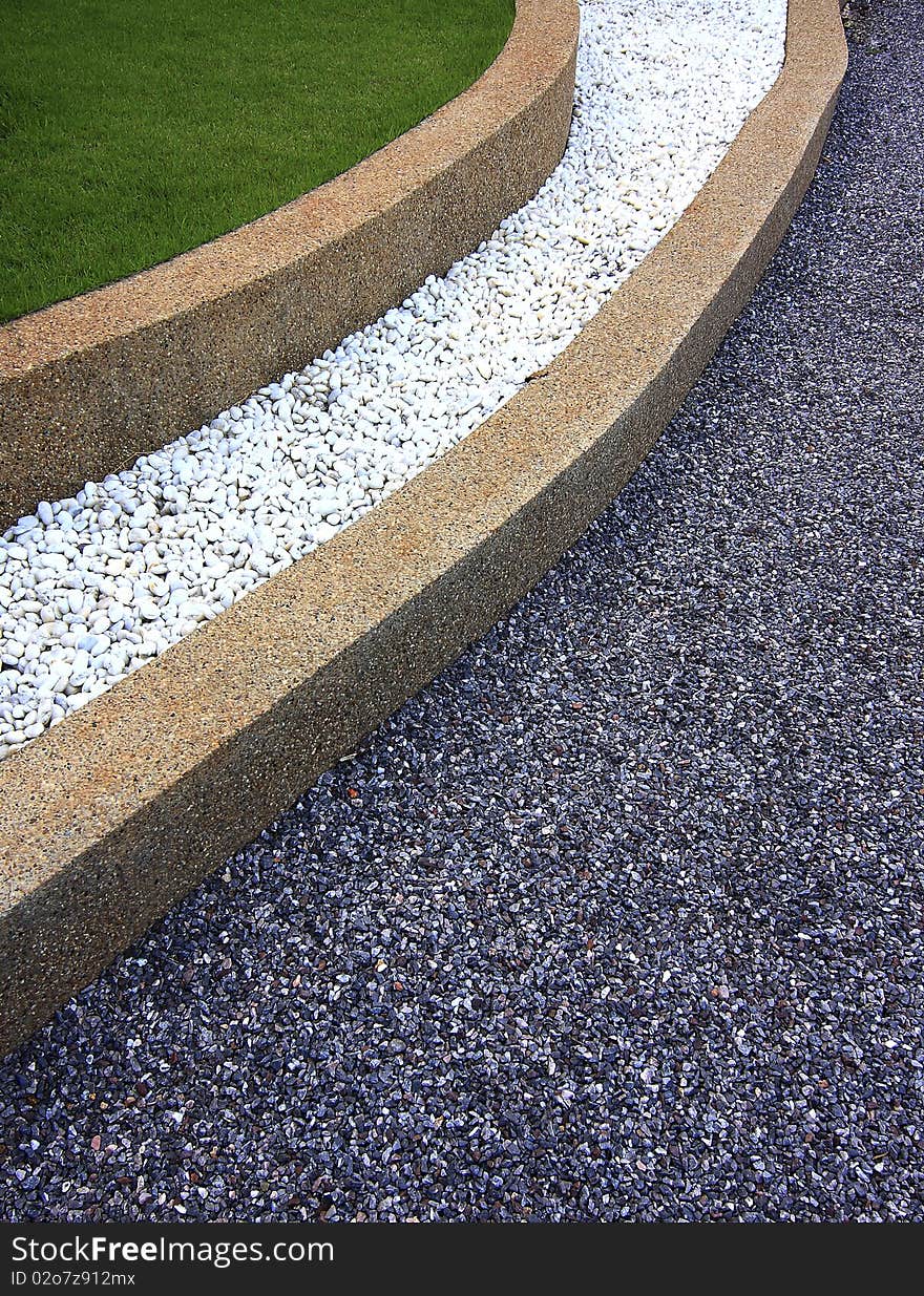 Garden stone path with grass growing up between the stones