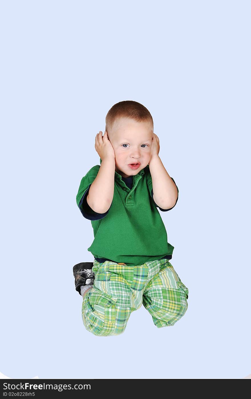 An little toddler boy holding his hands over his ears, he doesn�t like to hear what her mother is telling him, over light blue background. An little toddler boy holding his hands over his ears, he doesn�t like to hear what her mother is telling him, over light blue background.