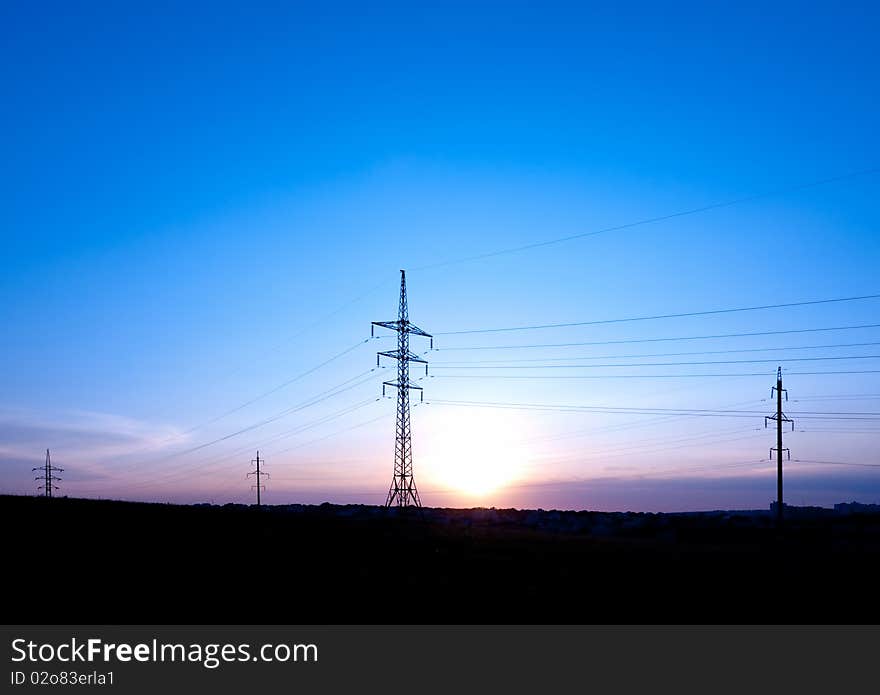 Powerlines. Sunset with silhouettes of pillar