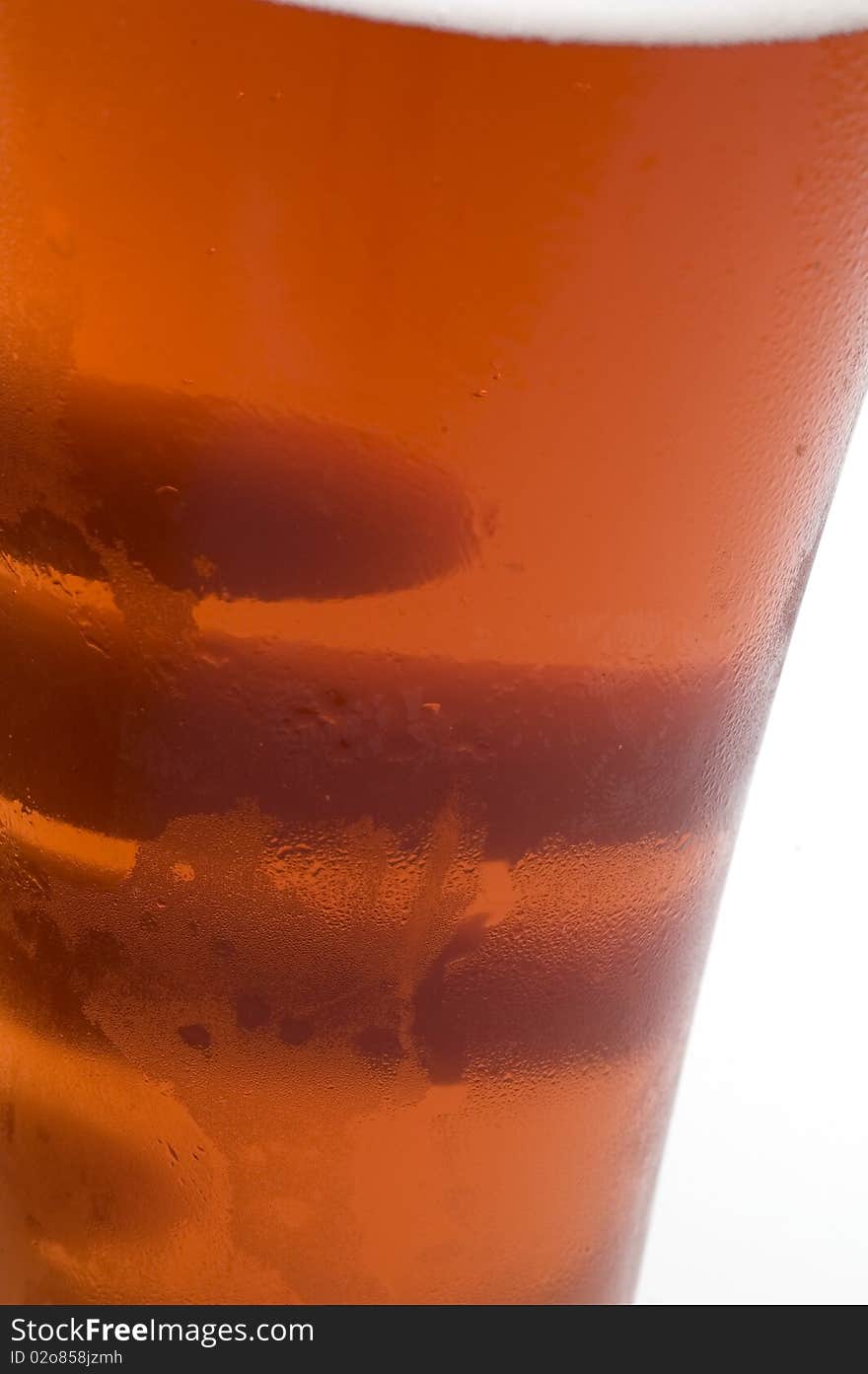 Hands Behind Beer Glass with Vibrant Color.