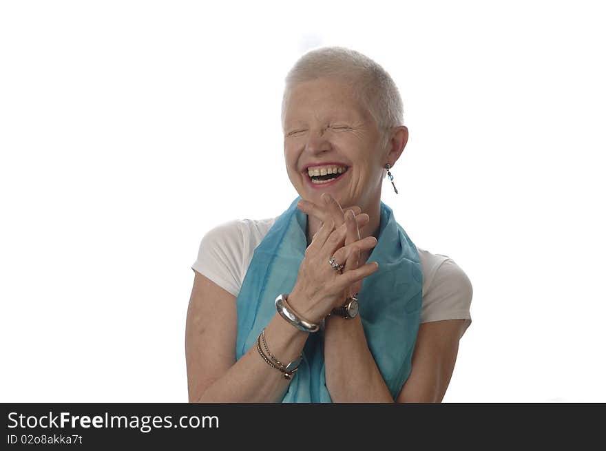 Senior woman laughs spontaneously in front of the white background. Senior woman laughs spontaneously in front of the white background.