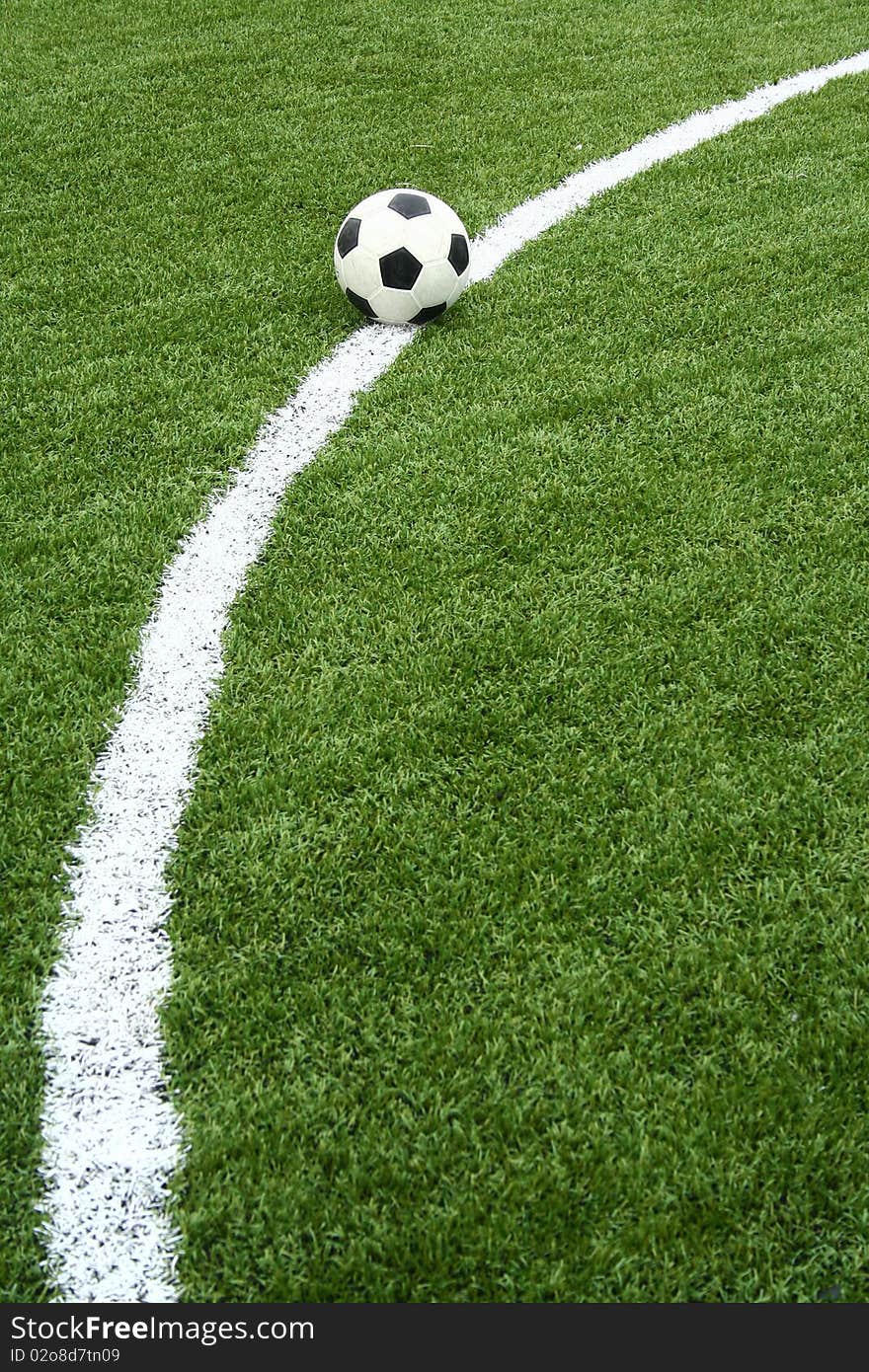 The soccer ball on soccer field with curve line. The soccer ball on soccer field with curve line