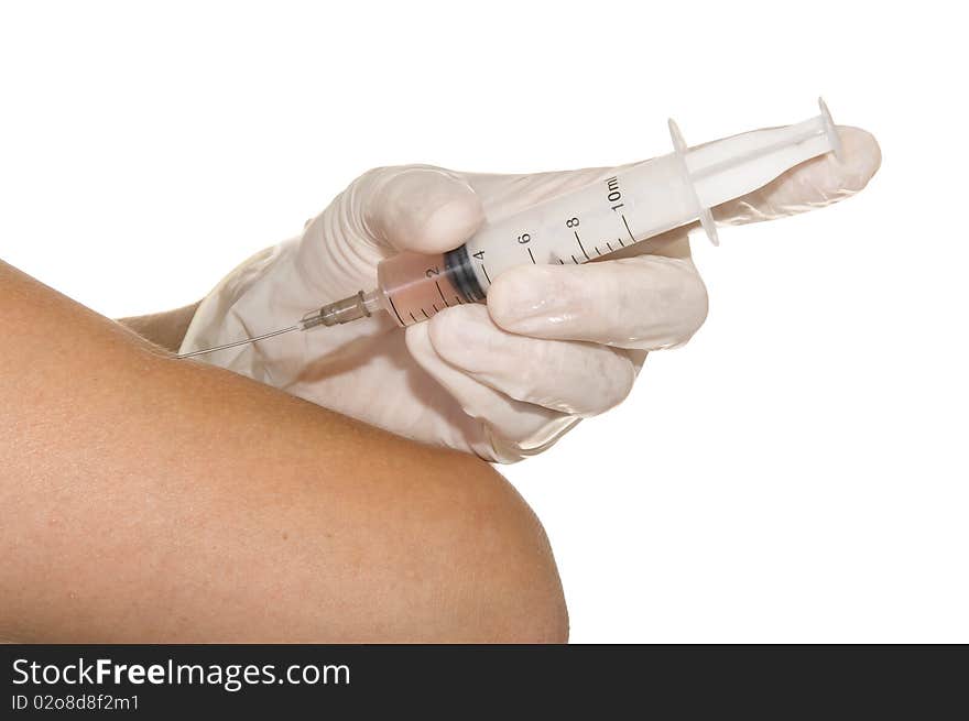 Syringe in his hand on a white background