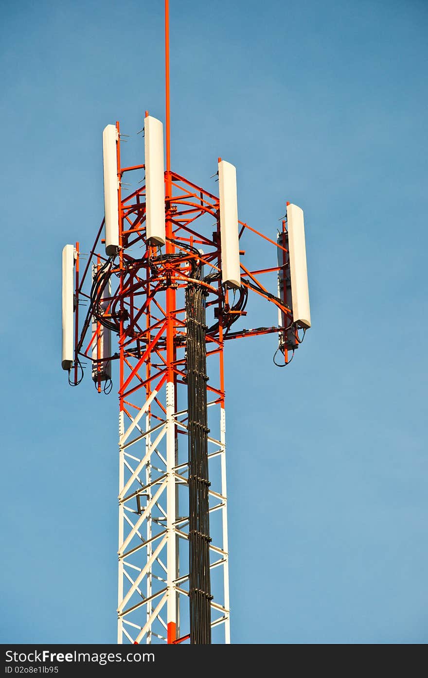 Communication tower against blue sky.