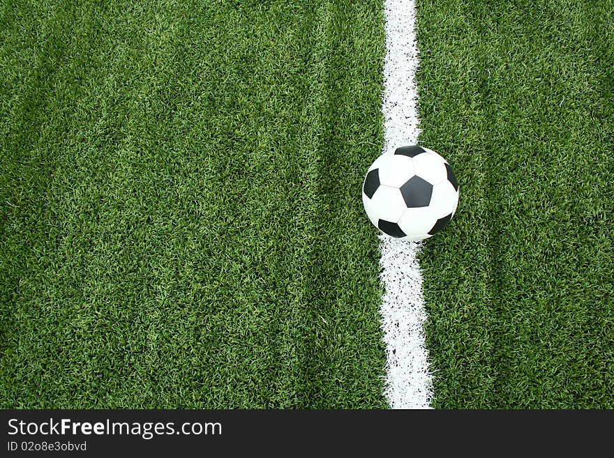 The football on soccer field with line