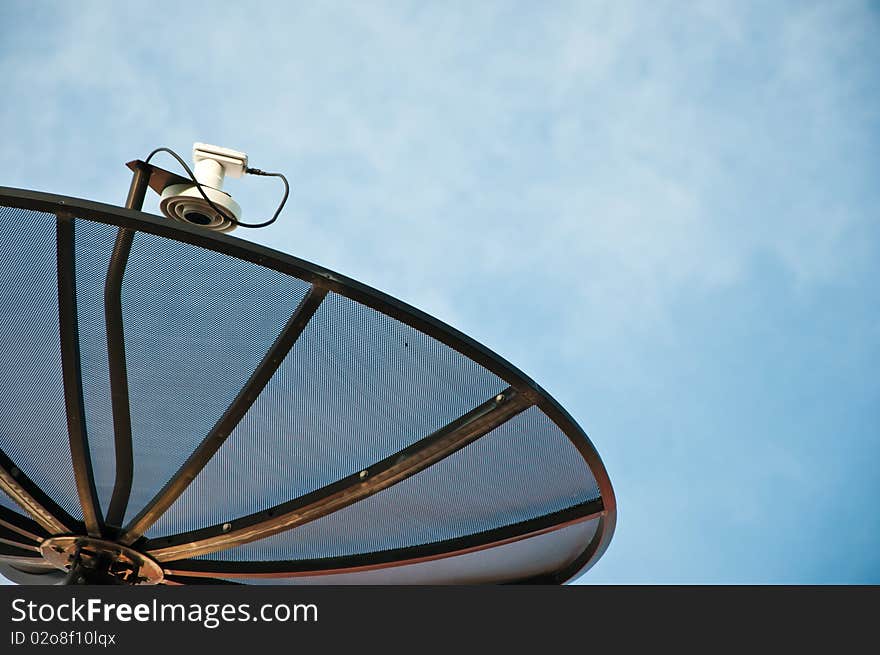 Closeup of a satellite dish with background of sky