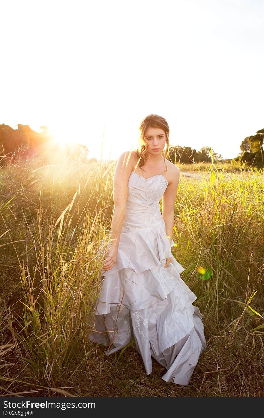 Attractive Young Woman Standing In The Grass