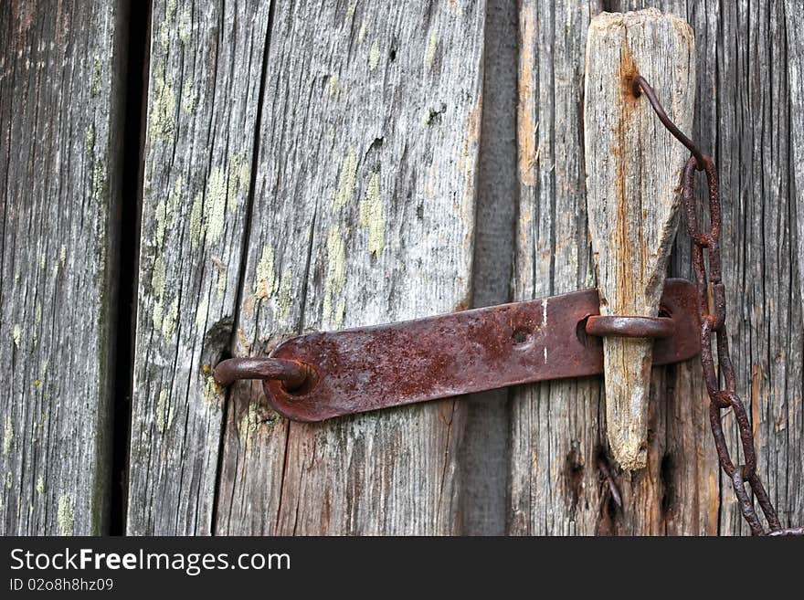 Old Wooden Door With A Padlock