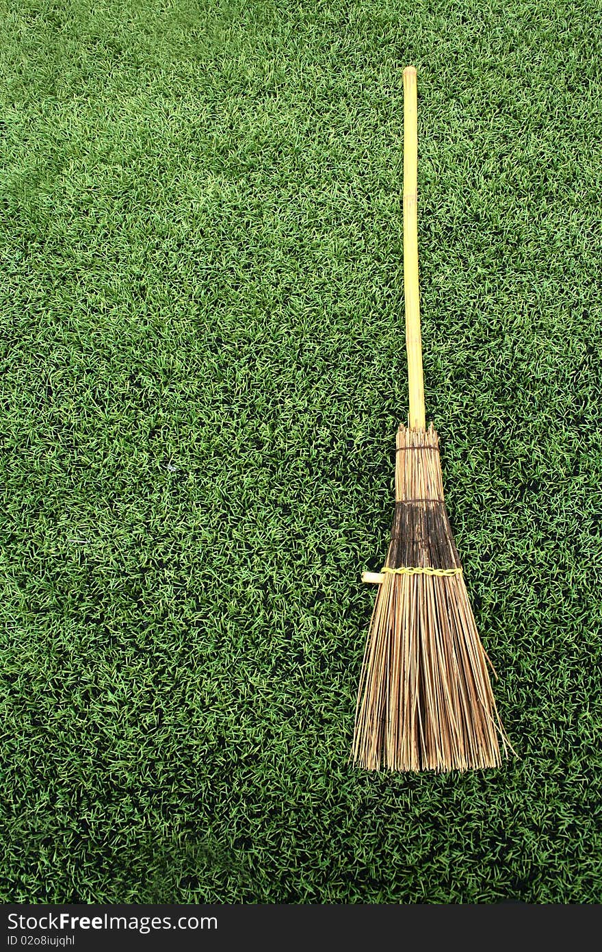 Broom on green grass