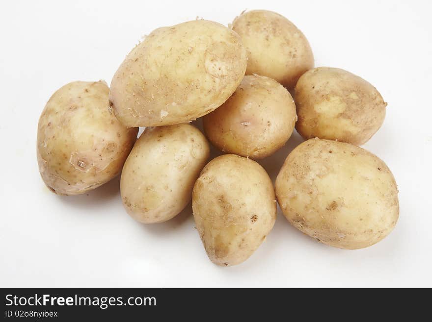 Bunch of potatoes on white background close up shoot