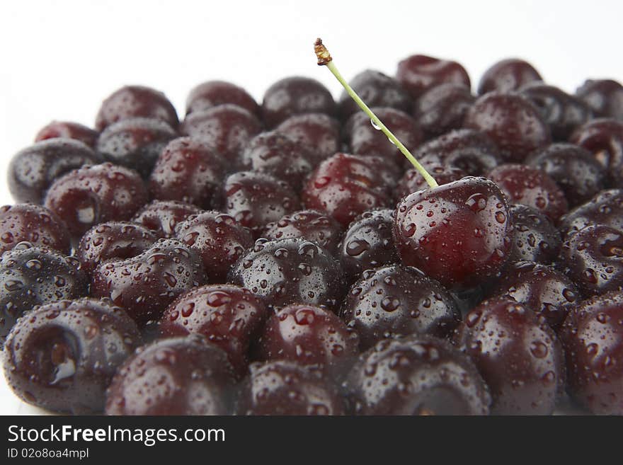 Fresh cherries with waterdrops on white background