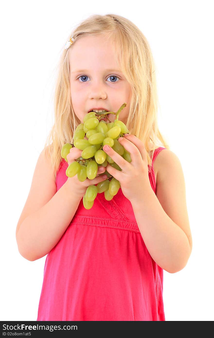 Little baby girl eats the big grapes, isolated on white