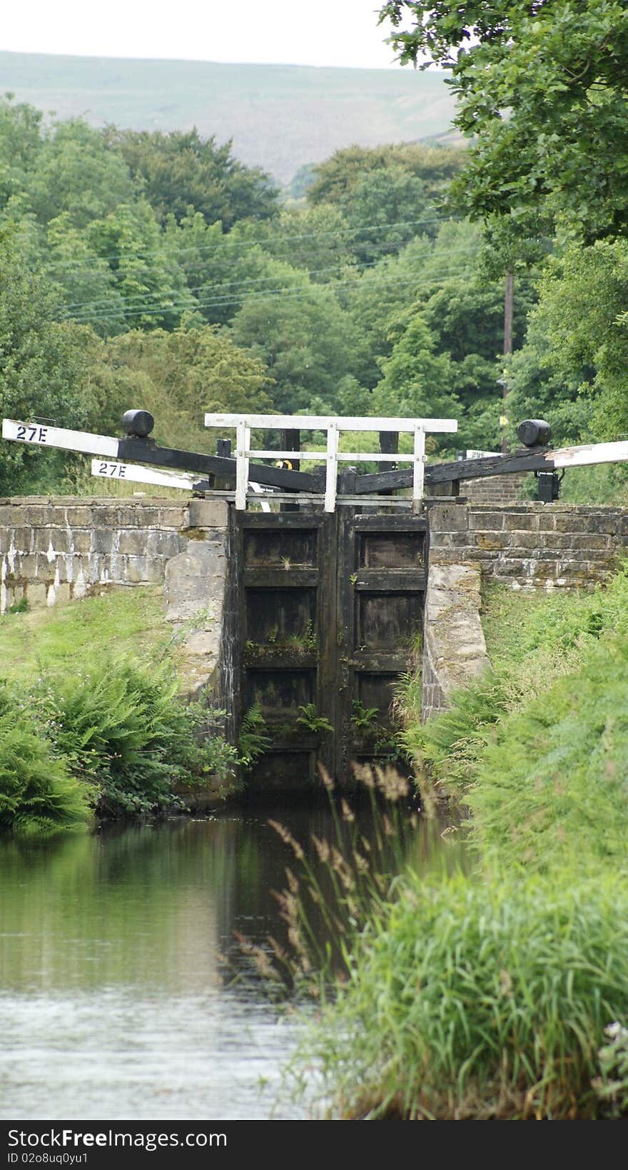 A canal lock in summer on the huddesfield narrow canal.