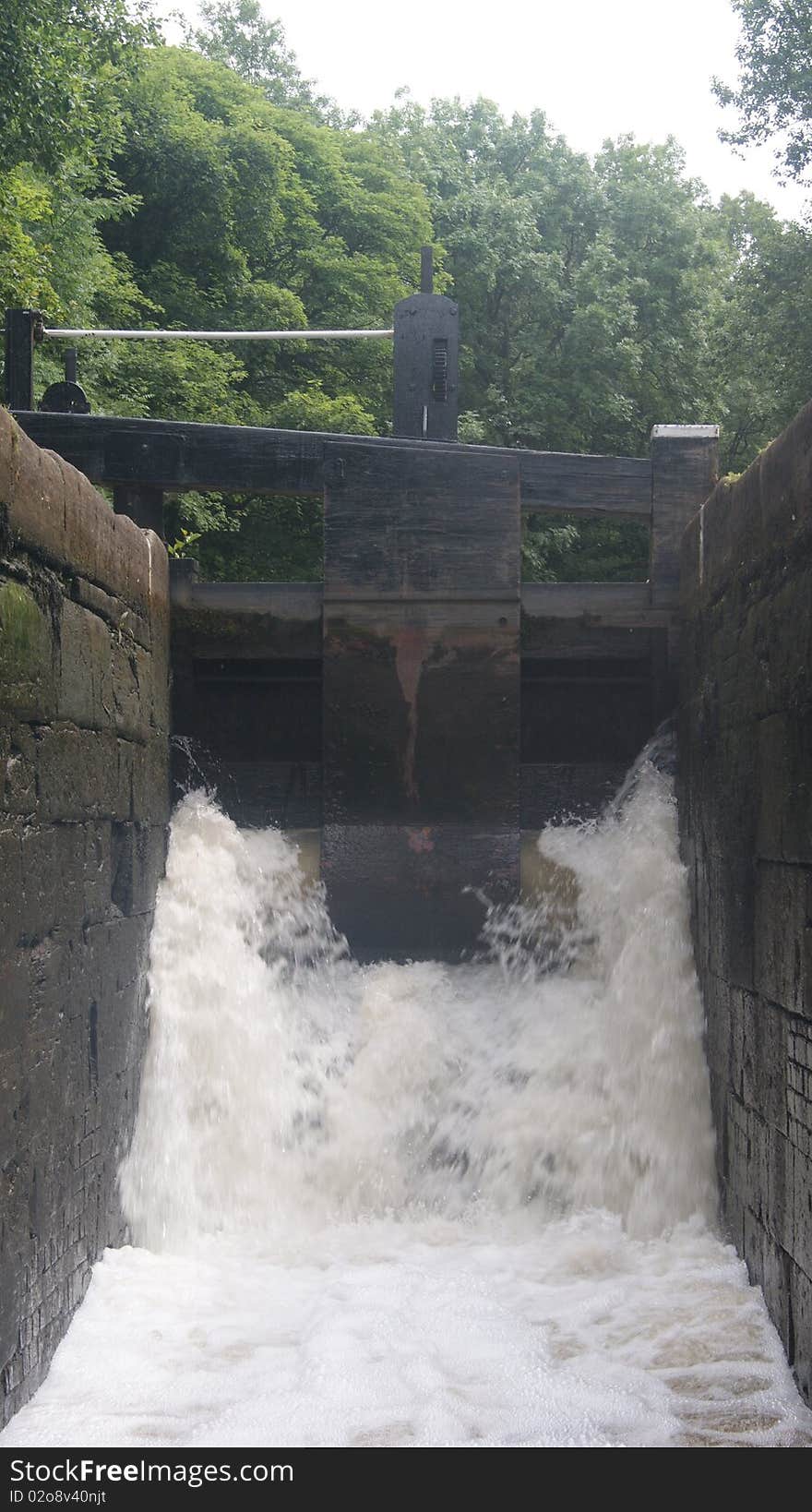 A canal lock filling up in summer on the huddesfield narrow canal.