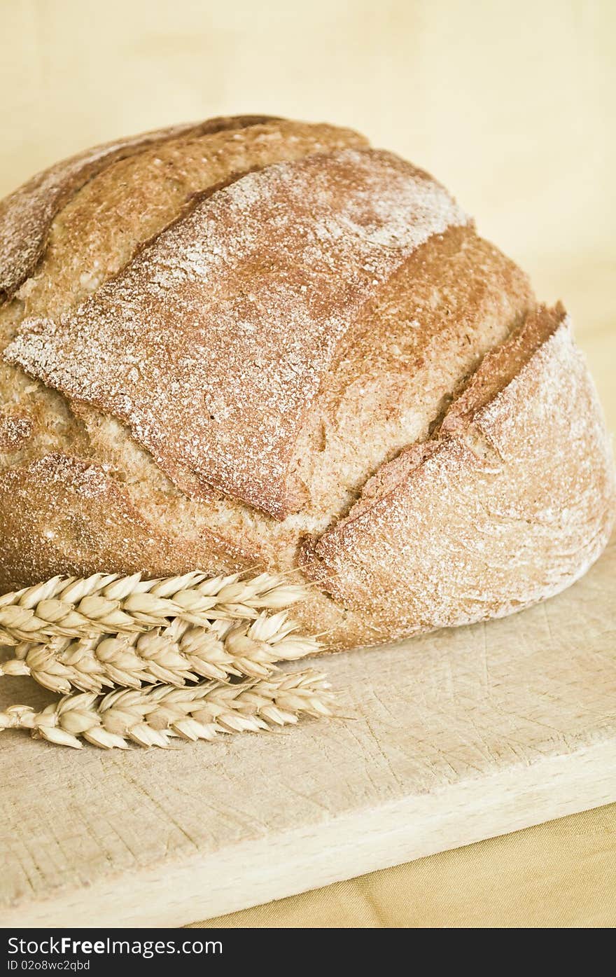 Fresh bred and wheat on wooden board. Fresh bred and wheat on wooden board