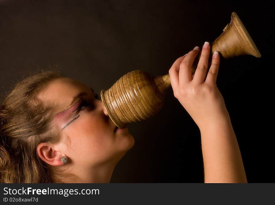 Girl holding goblet with vine. Girl holding goblet with vine