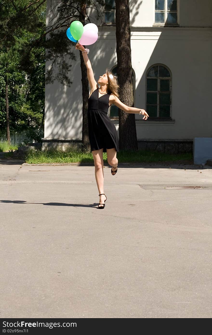 Joyful girl with balloons outdoor